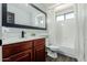 Clean bathroom with an updated vanity, black fixtures, and a shower-tub combination with tiled floors at 7204 S Golfside Ln, Phoenix, AZ 85042