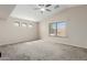 Spacious bedroom with a vaulted ceiling, large windows, and neutral carpeting, creating a bright, airy feel at 7204 S Golfside Ln, Phoenix, AZ 85042