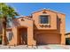 Charming two-story home featuring a stucco exterior, a terracotta roof, and a well-manicured front yard with desert landscaping at 7204 S Golfside Ln, Phoenix, AZ 85042
