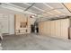 Well-organized garage with ample cabinet space and shelving for storage and projects at 7204 S Golfside Ln, Phoenix, AZ 85042