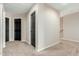 Upstairs hallway with neutral walls, carpet, and black doors provide access to various rooms at 7204 S Golfside Ln, Phoenix, AZ 85042