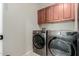 Laundry room features a washer and dryer set, cabinet storage, and convenient utility space at 7204 S Golfside Ln, Phoenix, AZ 85042