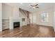 Inviting living room showcasing hardwood floors, a modern fireplace, and a staircase leading to the upper level of the home at 7204 S Golfside Ln, Phoenix, AZ 85042
