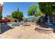 Inviting backyard featuring a pool, spa, fire pit, and meticulously landscaped surroundings for outdoor enjoyment at 7242 W Aurora Dr, Glendale, AZ 85308