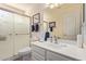 Modern bathroom featuring a glass shower enclosure, a sink with a white vanity, and a large mirror at 7242 W Aurora Dr, Glendale, AZ 85308