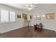 Versatile bedroom space, well-lit with natural light, features hardwood floors and a neutral color scheme at 7242 W Aurora Dr, Glendale, AZ 85308