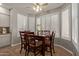 Bright dining area features white plantation shutters and a ceiling fan at 7242 W Aurora Dr, Glendale, AZ 85308