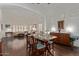 Dining room featuring hardwood floors, plantation shutters, and elegant decor at 7242 W Aurora Dr, Glendale, AZ 85308