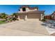 Home featuring a concrete driveway with a three car garage and desert landscaping at 7242 W Aurora Dr, Glendale, AZ 85308