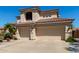 View of the front of the home featuring a three car garage and tile roof at 7242 W Aurora Dr, Glendale, AZ 85308