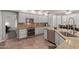 Kitchen featuring stainless appliances, granite counters and gray cabinetry at 7242 W Aurora Dr, Glendale, AZ 85308