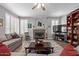 Comfortable living room features fireplace and plenty of seating at 7242 W Aurora Dr, Glendale, AZ 85308