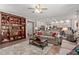 Open concept living area leading into the kitchen with large bookshelf at 7242 W Aurora Dr, Glendale, AZ 85308