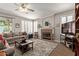 Spacious living room with fireplace, TV, and comfortable seating at 7242 W Aurora Dr, Glendale, AZ 85308