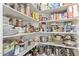 Walk-in pantry with lots of shelves for storage at 7242 W Aurora Dr, Glendale, AZ 85308