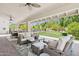 Covered patio featuring outdoor furniture, ceiling fans, stone flooring, and backyard at 7508 E Aster Dr, Scottsdale, AZ 85260