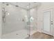 This modern bathroom has glass shower door, dual showerheads, white marble and tile, and a small bench at 7508 E Aster Dr, Scottsdale, AZ 85260