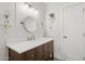 Well-lit bathroom featuring dark wood cabinets, white countertops, modern lighting and fixtures at 7508 E Aster Dr, Scottsdale, AZ 85260