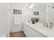 Beautiful bathroom with white cabinets, quartz countertops, dual sinks, and a tiled shower behind a glass door at 7508 E Aster Dr, Scottsdale, AZ 85260
