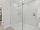 Bathroom with glass shower door, dual showerheads, white marble and tile, and a small bench at 7508 E Aster Dr, Scottsdale, AZ 85260