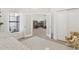 Bright bedroom showcases wood floors, interior view to great room, and a rocking chair at 7508 E Aster Dr, Scottsdale, AZ 85260