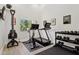 A dedicated exercise room with a treadmill, stationary bike, weight rack, and a large window for natural light at 7508 E Aster Dr, Scottsdale, AZ 85260
