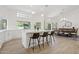 Bright kitchen with a large island, modern stools, and an open view into the dining area at 7508 E Aster Dr, Scottsdale, AZ 85260