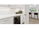 Stylish kitchen area with wine fridge, bright lighting, and quartz countertops at 7508 E Aster Dr, Scottsdale, AZ 85260