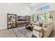 Comfortable living room with vaulted ceilings, neutral furniture, decorative rug, and view of the backyard at 7508 E Aster Dr, Scottsdale, AZ 85260