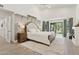 This is a spacious and bright main bedroom with light hardwood floors and a sliding glass door to the backyard at 7508 E Aster Dr, Scottsdale, AZ 85260