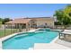 Beautiful backyard pool and spa with views of the home's exterior, solar panels, and desert landscaping at 7508 E Aster Dr, Scottsdale, AZ 85260