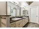 Bathroom with dual sinks, dark granite countertops, and white cabinetry at 7601 E Indian Bend Rd # 3002, Scottsdale, AZ 85250