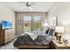 Bedroom features a ceiling fan, large windows, and neutral décor at 7601 E Indian Bend Rd # 3002, Scottsdale, AZ 85250