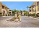 Inviting gated community entrance with lush landscaping and a clear view of the well-maintained building exteriors at 7601 E Indian Bend Rd # 3002, Scottsdale, AZ 85250