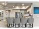 Modern kitchen island with seating and stainless steel appliances and ample cabinet space at 7601 E Indian Bend Rd # 3002, Scottsdale, AZ 85250