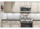 Updated kitchen showcasing stainless steel appliances, stylish backsplash, and abundant storage at 7601 E Indian Bend Rd # 3002, Scottsdale, AZ 85250