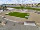 Community game area featuring a bean bag toss game, seating, landscaping, and community park at 8149 E Petunia Ave # 1013, Mesa, AZ 85212
