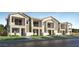 Charming townhome showcasing a two-story design, private balconies, and manicured landscaping, all set against a clear blue sky at 8149 E Petunia Ave # 1013, Mesa, AZ 85212