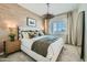 Well-lit main bedroom with a textured accent wall, large window, and tastefully appointed decor at 8149 E Petunia Ave # 1042, Mesa, AZ 85212