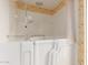 Walk-in bathtub with safety bars in bathroom with patterned wallpaper accents at 8337 E Desert Trl, Mesa, AZ 85208