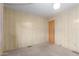Bedroom with neutral carpet, wood-paneled walls, and an access door at 8337 E Desert Trl, Mesa, AZ 85208