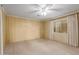 Spacious bedroom featuring a ceiling fan, neutral carpet, and bright window views at 8337 E Desert Trl, Mesa, AZ 85208