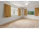 Spacious bedroom with carpet flooring, ceiling fan, and abundant natural light from large windows at 8337 E Desert Trl, Mesa, AZ 85208