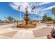 Community fountain featuring flags, landscaping, benches, and an open space with desert scenery at 8337 E Desert Trl, Mesa, AZ 85208