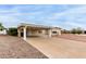 Exterior of home with carport and gravel landscaping under a partly cloudy sky at 8337 E Desert Trl, Mesa, AZ 85208
