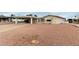 Exterior view of property with a carport and minimal landscaping under a cloudy sky at 8337 E Desert Trl, Mesa, AZ 85208