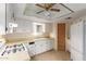 Well-lit kitchen with white cabinets, modern appliances, and convenient layout at 8337 E Desert Trl, Mesa, AZ 85208