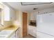 Bright kitchen featuring white cabinets, linoleum countertops, and a ceiling fan at 8337 E Desert Trl, Mesa, AZ 85208