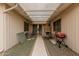Covered patio area featuring outdoor seating, a grill, and lattice roofing at 8337 E Desert Trl, Mesa, AZ 85208