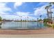 Community pond with fountains and palm trees, creating a scenic and tranquil environment at 8337 E Desert Trl, Mesa, AZ 85208